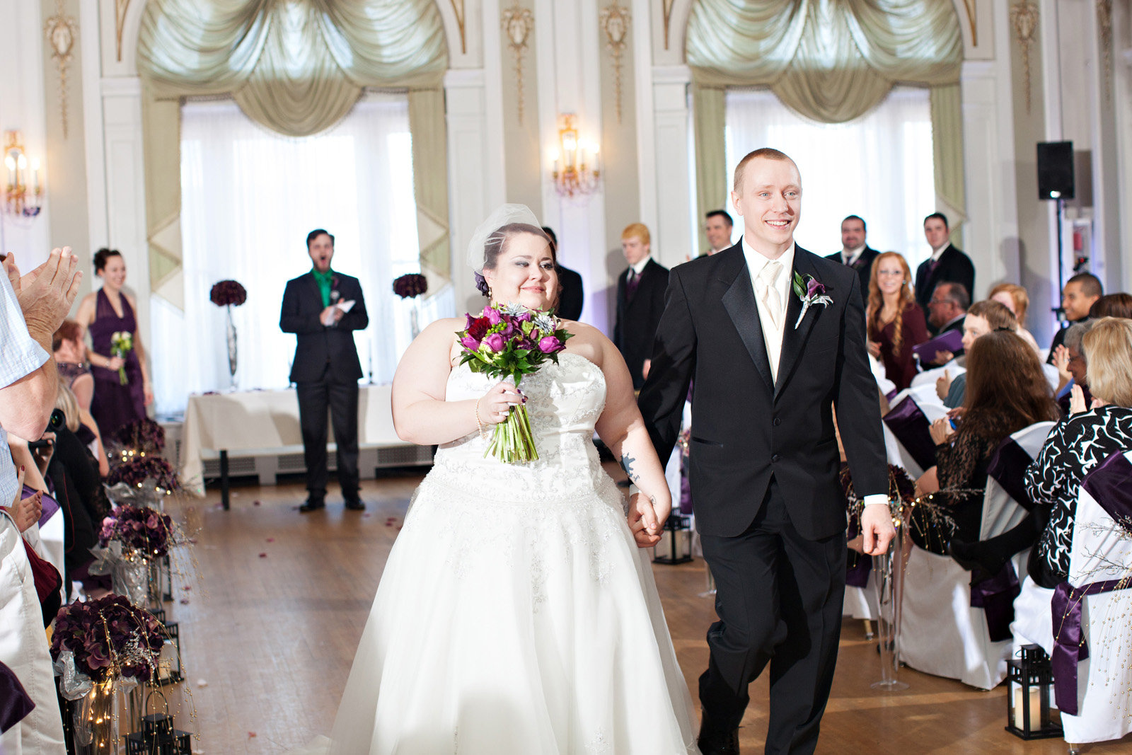 A bride & groom walk down the aisle during the wedding recessional